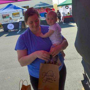 Family leaving the market with shopping bags in hand