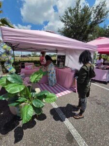 man looking at a booth at sunday market jacksonville
