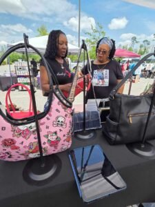 two women viewing purses at a sunday market jacksonville