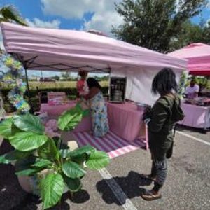 Shopper chatting with a local vendor at their tent
